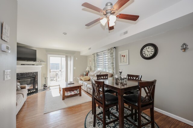 11 Sullivan Way Unit 6, Laconia, NH 03246 - dining area with wood finished floors, a ceiling fan, a fireplace, and baseboards