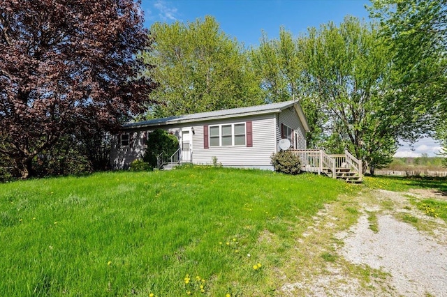 2099 W Shore Rd, Alburgh, VT 05440 - view of front of property with a wooden deck, entry steps, and a front lawn