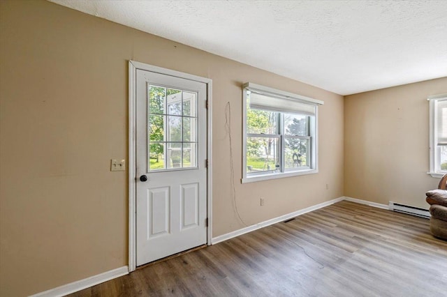 2099 W Shore Rd, Alburgh, VT 05440 - foyer featuring a baseboard heating unit, wood finished floors, and baseboards