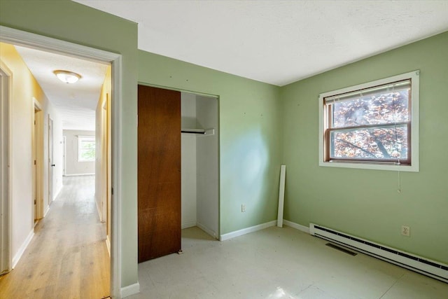 2099 W Shore Rd, Alburgh, VT 05440 - unfurnished bedroom featuring a baseboard radiator, baseboards, and a closet