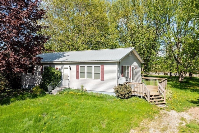 2099 W Shore Rd, Alburgh, VT 05440 - view of front facade with a front lawn, a deck, and metal roof