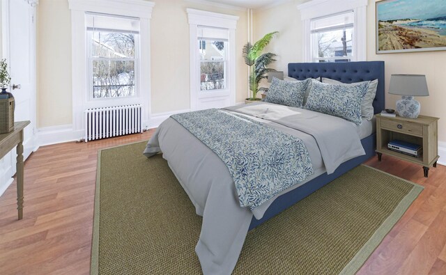47 Pitkin St, Burlington, VT 05401 - bedroom featuring radiator heating unit, multiple windows, and wood finished floors