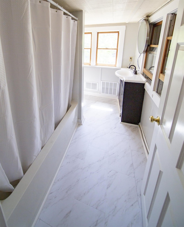 47 Pitkin St, Burlington, VT 05401 - full bathroom featuring marble look tile flooring, vanity, and shower / bath combo with shower curtain
