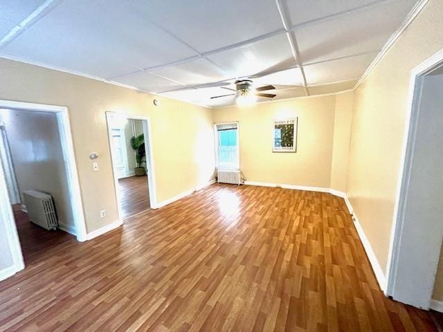 47 Pitkin St, Burlington, VT 05401 - unfurnished room with radiator heating unit, wood finished floors, ceiling fan, baseboards, and crown molding