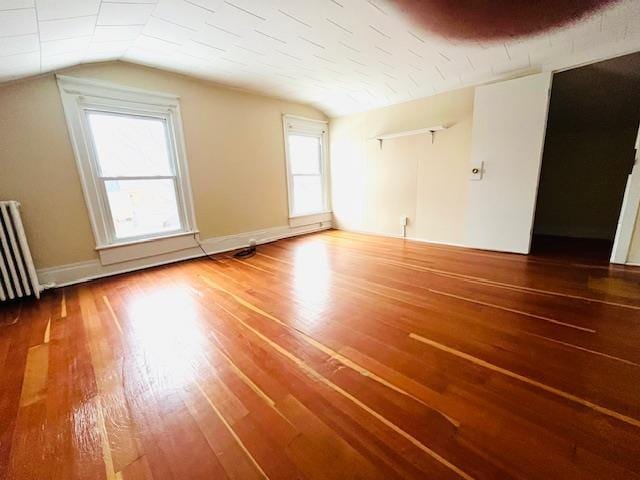 47 Pitkin St, Burlington, VT 05401 - additional living space featuring radiator heating unit, wood finished floors, vaulted ceiling, and baseboards
