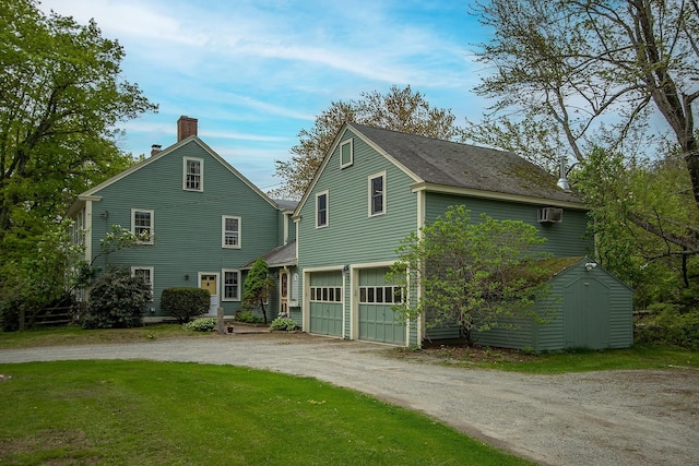 685 Abbot Hill Rd, Wilton, NH 03086 - view of front of home featuring dirt driveway, an attached garage, a chimney, a storage shed, and an outdoor structure