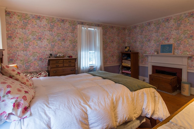 685 Abbot Hill Rd, Wilton, NH 03086 - bedroom with wood finished floors, crown molding, a fireplace, and wallpapered walls