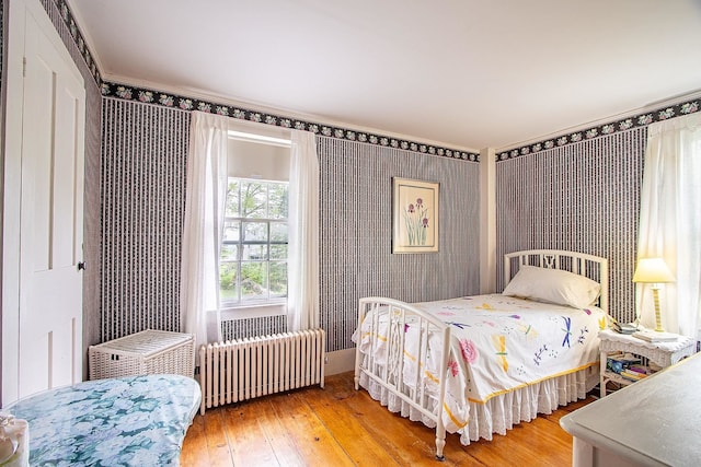 685 Abbot Hill Rd, Wilton, NH 03086 - bedroom featuring radiator, wallpapered walls, and wood-type flooring