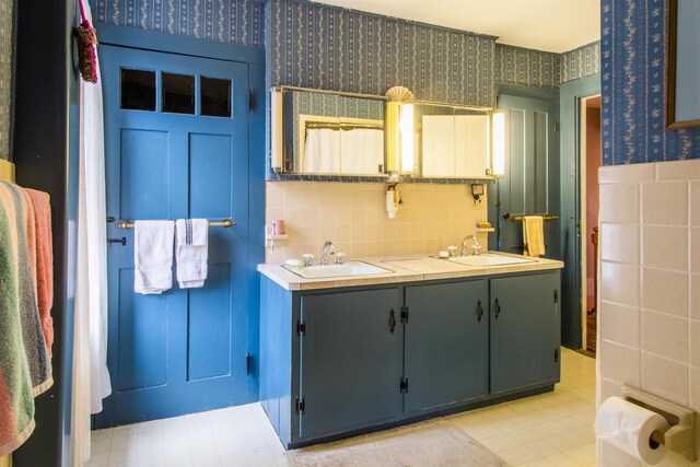 685 Abbot Hill Rd, Wilton, NH 03086 - full bath featuring tile walls, tile patterned floors, wallpapered walls, and double vanity