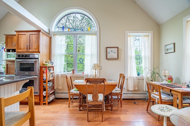 685 Abbot Hill Rd, Wilton, NH 03086 - dining space with light wood-style flooring, high vaulted ceiling, and baseboard heating