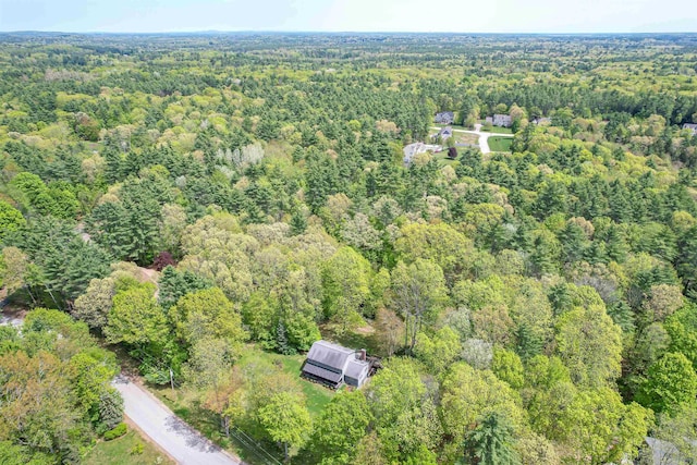 aerial overview of property's location with a heavily wooded area