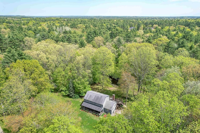 view from above of property with a heavily wooded area