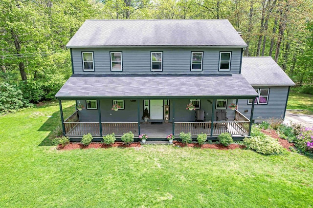 view of front of property featuring roof with shingles, a front yard, and a porch