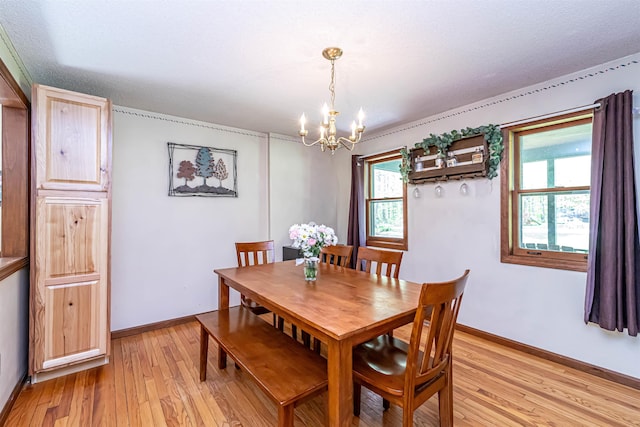dining room featuring a chandelier, light wood finished floors, and plenty of natural light