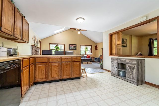 kitchen with dishwasher, a peninsula, plenty of natural light, ceiling fan, and vaulted ceiling