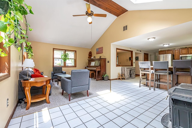 living room featuring ceiling fan, baseboards, light carpet, and high vaulted ceiling