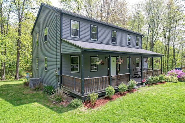 view of front of property featuring a porch, central AC, and a front lawn