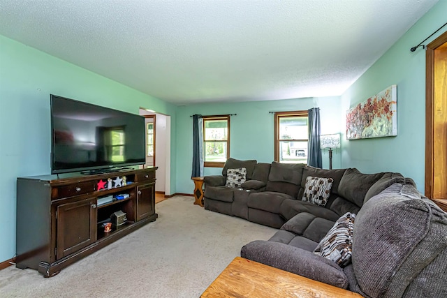 living room featuring light carpet, a textured ceiling, and baseboards