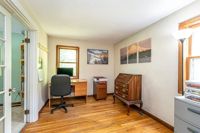 office featuring light wood-type flooring and baseboards