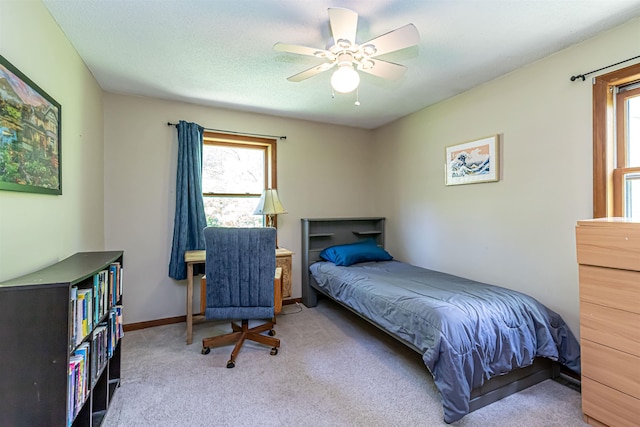 bedroom featuring carpet, a ceiling fan, and baseboards