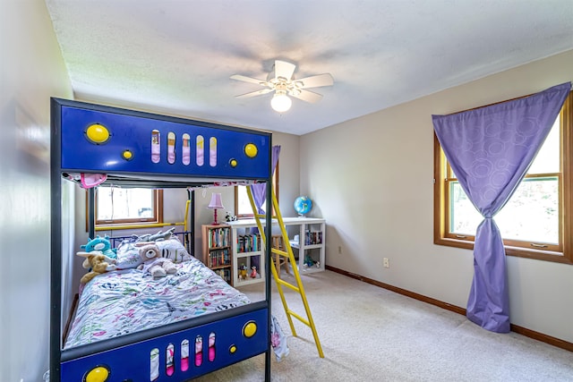 bedroom with carpet flooring, baseboards, and ceiling fan