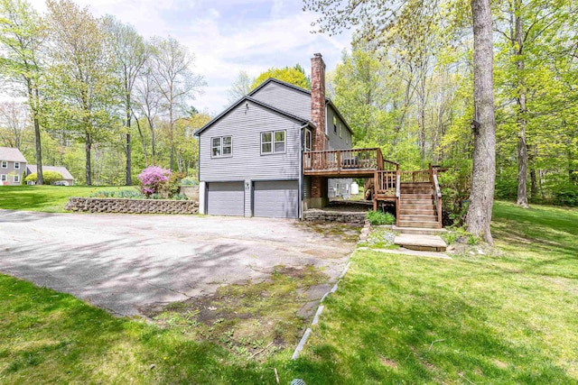 view of property exterior with stairs, a deck, driveway, an attached garage, and a chimney
