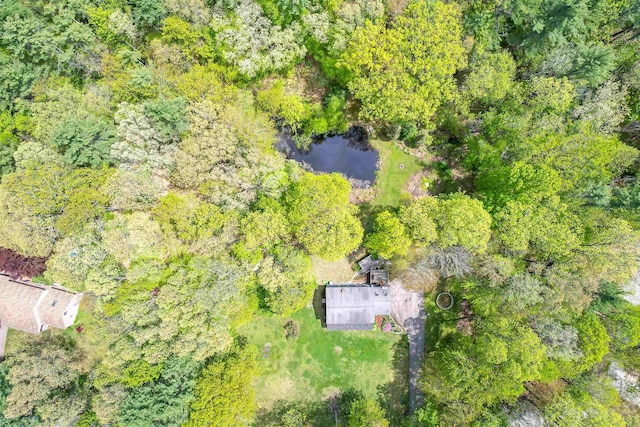 view of subject property with a heavily wooded area
