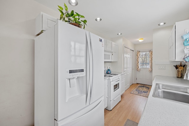 28 Lindsley Cir, Campton, NH 03223 - kitchen featuring white appliances, light wood-style floors, white cabinetry, a sink, and light countertops