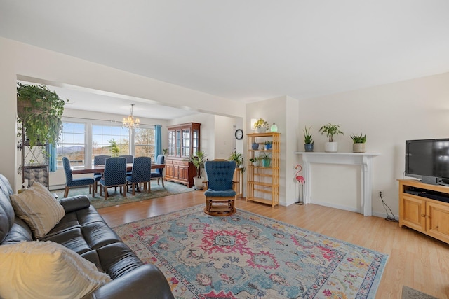 28 Lindsley Cir, Campton, NH 03223 - living area featuring a chandelier, light wood-style flooring, and baseboards