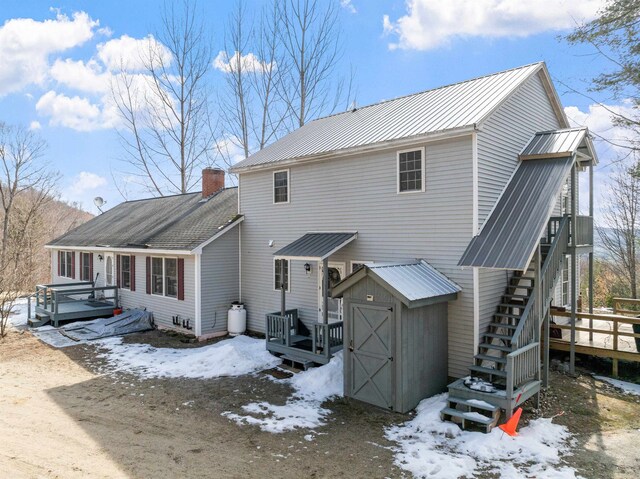28 Lindsley Cir, Campton, NH 03223 - snow covered property with a wooden deck, metal roof, and stairs