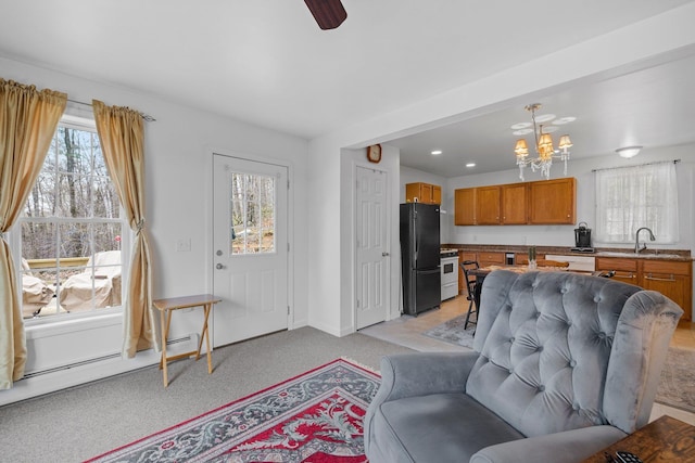 28 Lindsley Cir, Campton, NH 03223 - living room featuring a chandelier, light carpet, plenty of natural light, and a baseboard heating unit