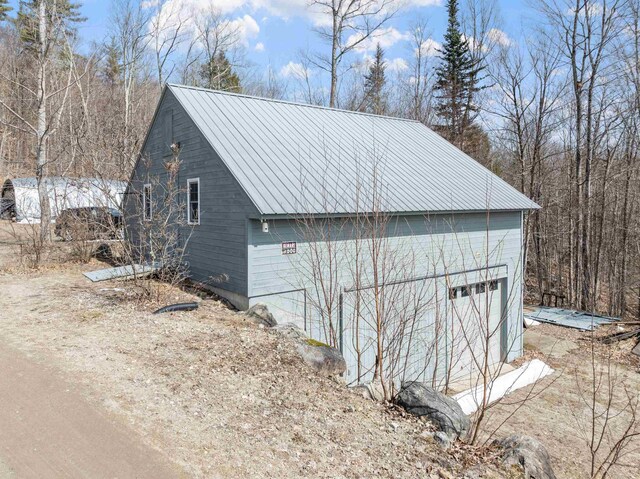 28 Lindsley Cir, Campton, NH 03223 - view of side of property featuring metal roof and a garage