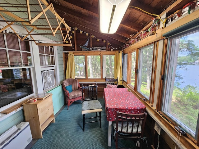 sunroom / solarium featuring lofted ceiling, wooden ceiling, carpet flooring, plenty of natural light, and a water view