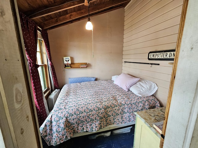 bedroom featuring radiator heating unit, wood walls, and wood ceiling