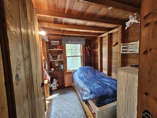 bedroom with wood walls, beam ceiling, wood ceiling, and carpet floors