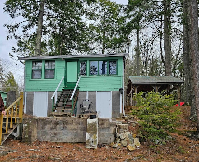 view of front of home featuring stairway