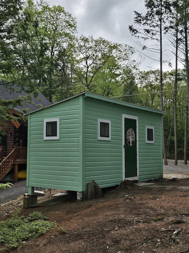 view of outbuilding with an outdoor structure and stairs