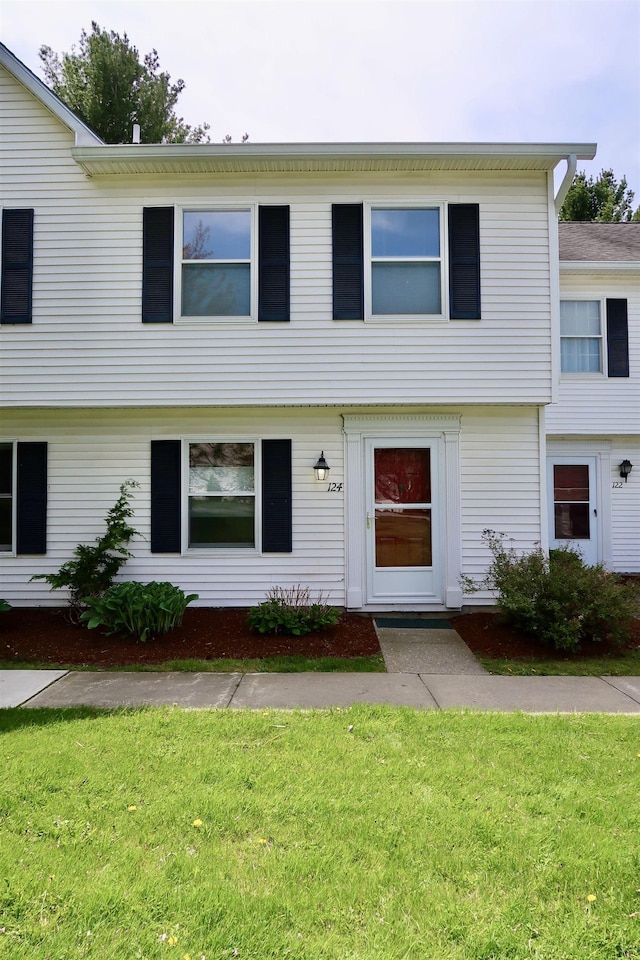 colonial-style house featuring a front lawn