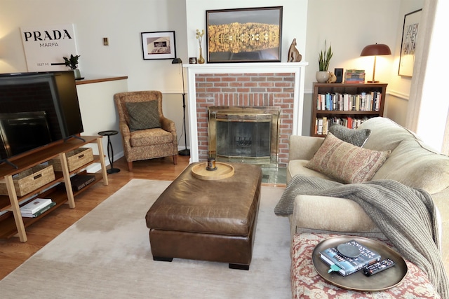 living area with wood finished floors and a fireplace
