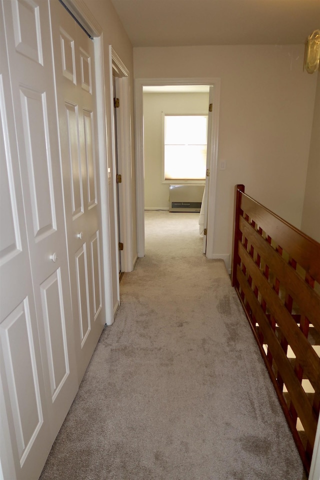 corridor with light carpet and baseboards