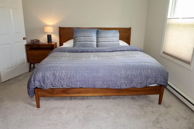 carpeted bedroom with a baseboard radiator
