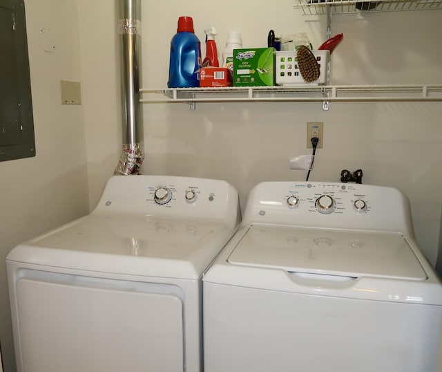 laundry area with washing machine and clothes dryer and electric panel