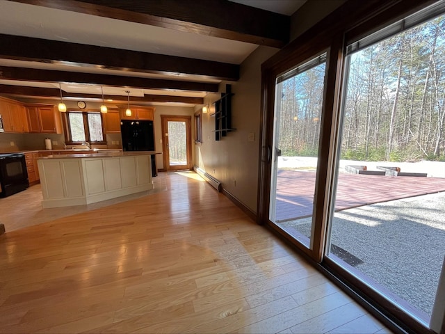 80 Mill St, Conway, NH 03813 - kitchen featuring black range with electric cooktop, light wood-style floors, beamed ceiling, baseboard heating, and a sink
