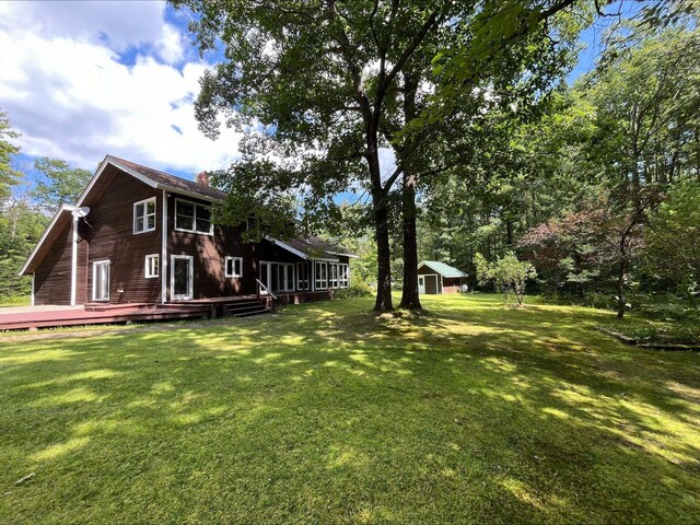 80 Mill St, Conway, NH 03813 - view of grassy yard featuring a deck and an outdoor structure