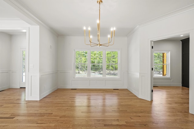 286 S Rd, Brentwood, NH 03833 - unfurnished dining area featuring a chandelier, light wood-style flooring, a wainscoted wall, ornamental molding, and a decorative wall