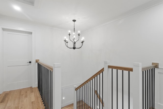 286 S Rd, Brentwood, NH 03833 - staircase featuring wood finished floors, a chandelier, and crown molding