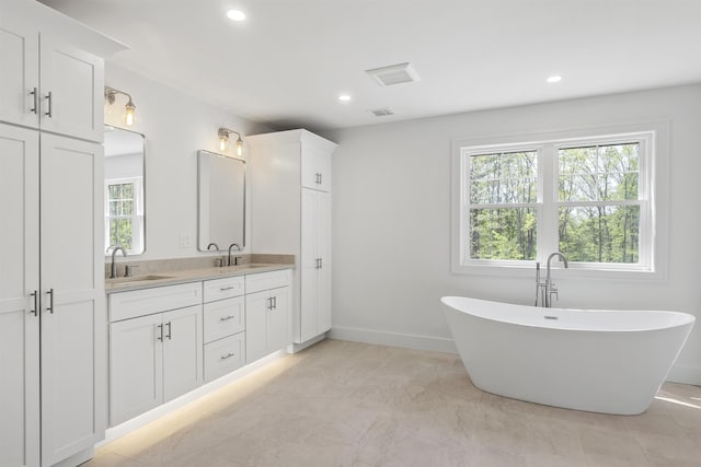 286 S Rd, Brentwood, NH 03833 - bathroom with double vanity, healthy amount of natural light, a freestanding tub, and recessed lighting