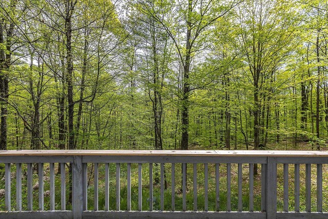 258 Densmore Hill Rd, Hartland, VT 05048 - wooden terrace with a view of trees