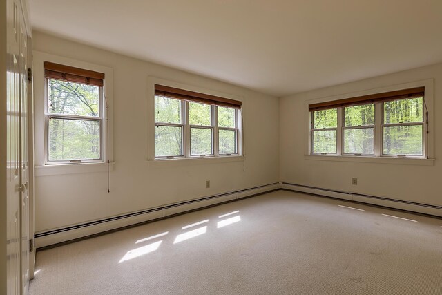 258 Densmore Hill Rd, Hartland, VT 05048 - carpeted empty room featuring plenty of natural light and a baseboard heating unit