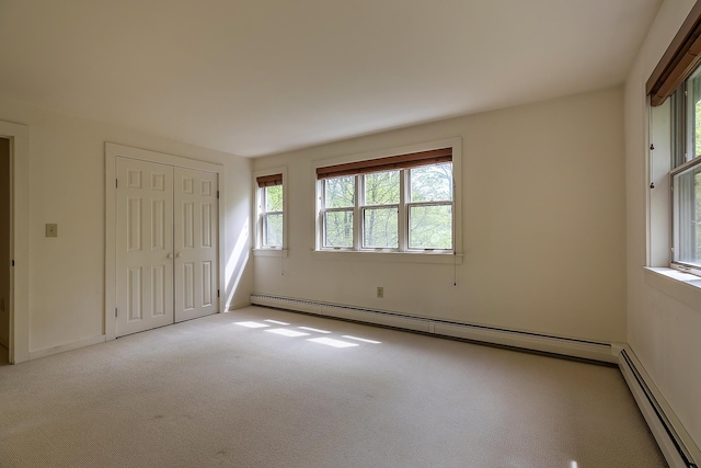 258 Densmore Hill Rd, Hartland, VT 05048 - unfurnished bedroom with a baseboard heating unit, carpet floors, a baseboard radiator, and a closet